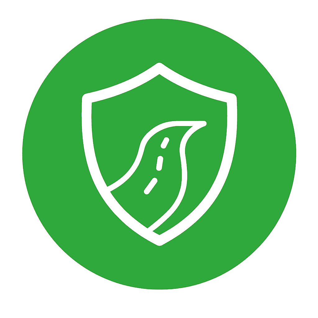 White shield with a curved road inside, on a green circular background symbolizing reliable travel protection and safety coverage.